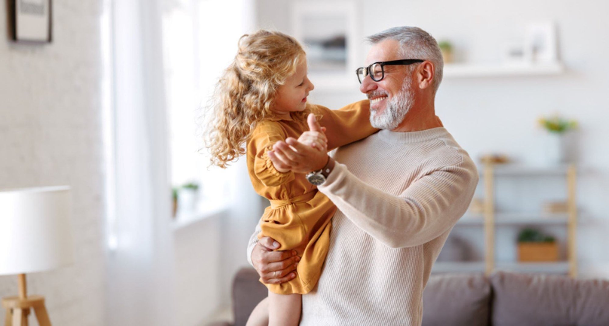 grandfather dancing with grand daughter