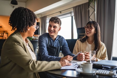 Young man entrepreneur on the meeting with female banker